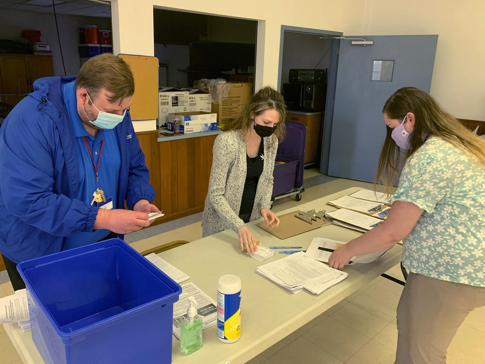 Holmes County, Ohio, General Health District staff members (from left) Michael Derr, Jennifer Talkington and Abbie Benton prepare materials for a COVID-19 vaccine clinic this month inside St. Peter's Catholic Church in Millersburg.