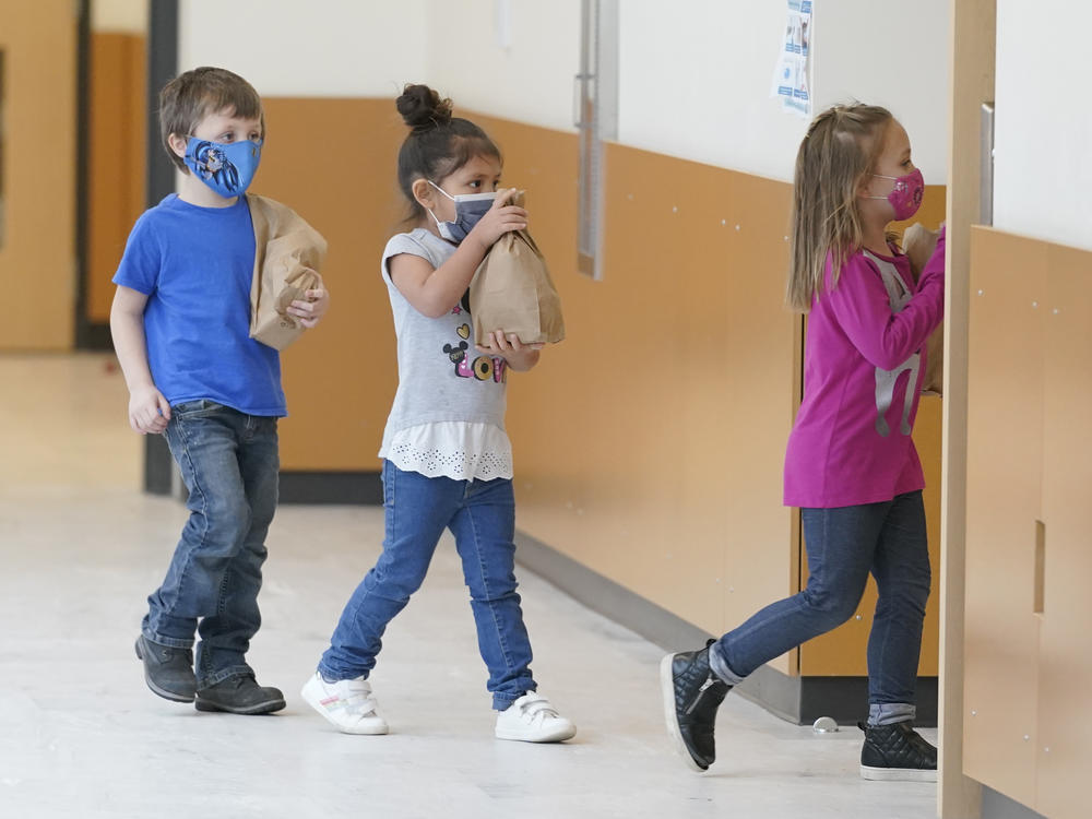 Students carry sack lunches at Elk Ridge Elementary School in Buckley, Wash. On Monday, USDA unveiled a new program that would feed millions of children over the summer, when many schools are closed.