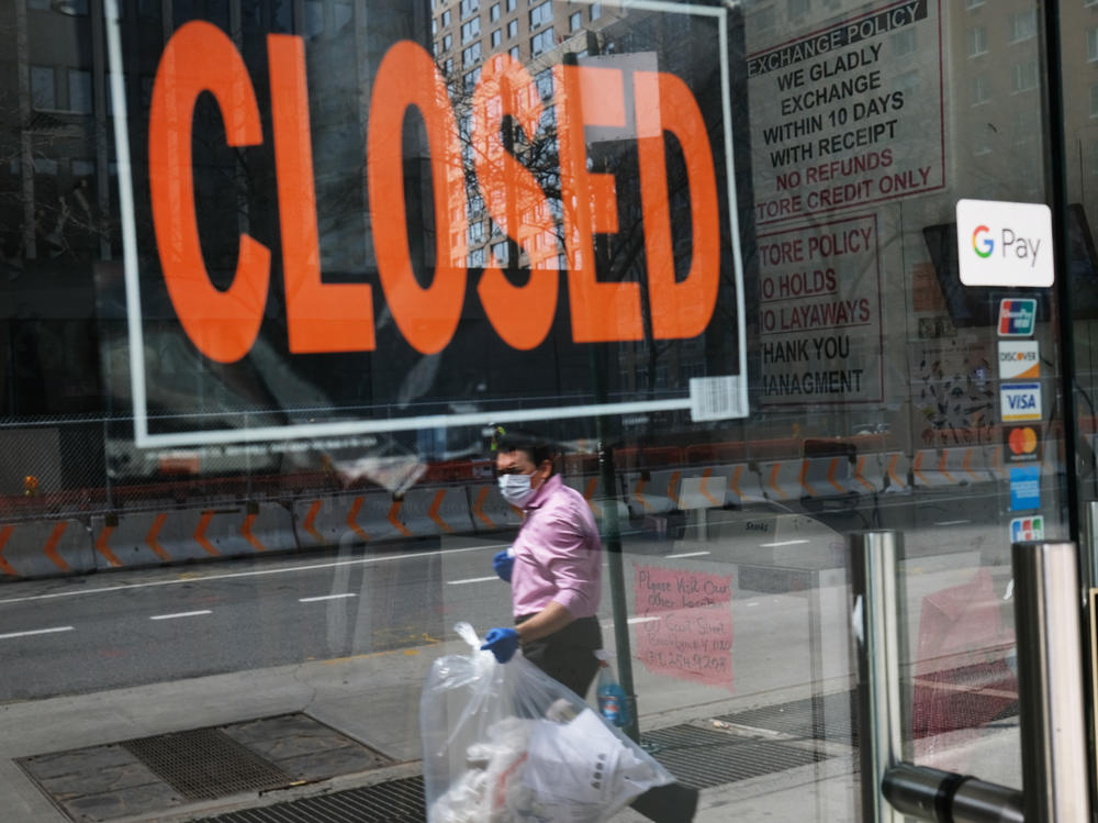 A closed sign is displayed in the window of a business in a nearly deserted lower Manhattan on April 17, 2020, in New York. Many small businesses benefited from a government emergency loan program during the pandemic, but its effectiveness is still in doubt.
