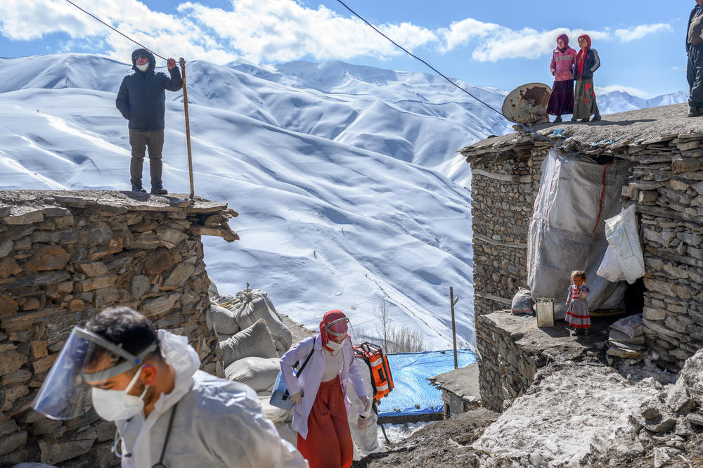 Dr. Sergen Saracoglu (left) and nurse Yilzdiz Ayten (center)  arrive at the village of Guneyyamac in Turkey on Feb. 15 as part of an expedition to vaccinate residents 65 years and over with Sinovac's CoronaVac COVID-19 vaccine.