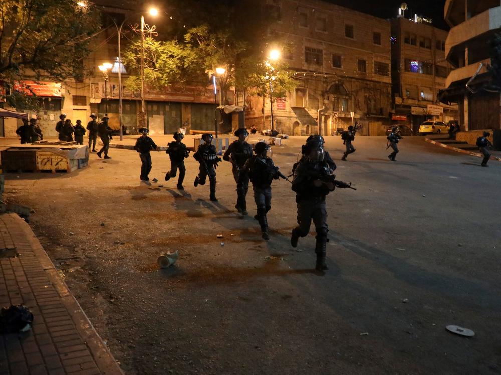 Israeli security forces on a street during clashes with Palestinian youth in Hebron on April 25.