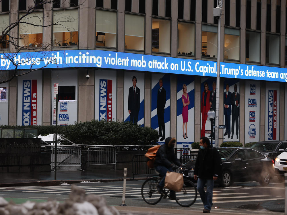 News headlines on the impeachment trial of Donald Trump are displayed outside Fox headquarters in February in New York City.