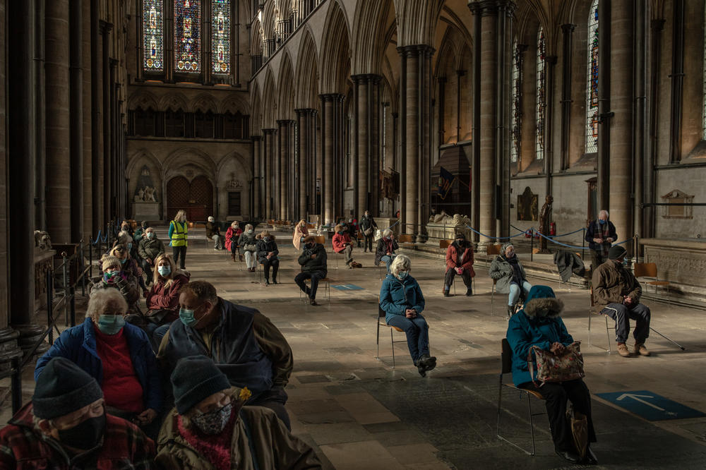 People wait to see if they have a reaction after receiving COVID-19 vaccines at a vaccination center in February at Salisbury Cathedral in Salisbury, England.