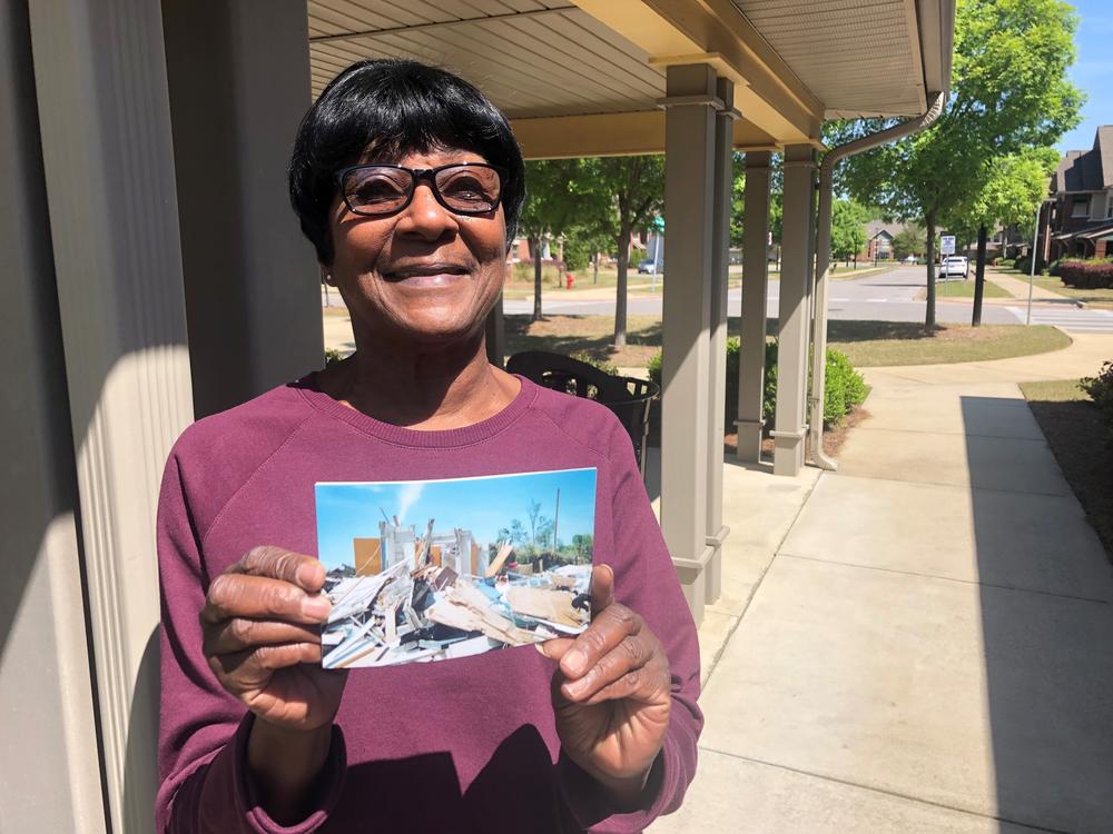 Jeanette Barnes displays an image showing the damage done to her apartment 10 years ago during the deadly Tuscaloosa, Ala., tornado.