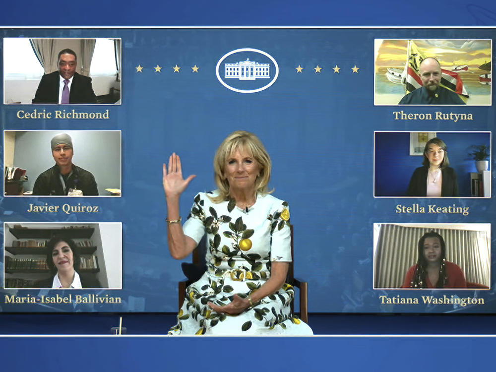 An image from video provided by the White House shows first lady Jill Biden meeting with her virtual guests ahead of President Biden's joint address on Wednesday. Many Democratic lawmakers are also naming guests of honor, who will be watching the speech remotely.