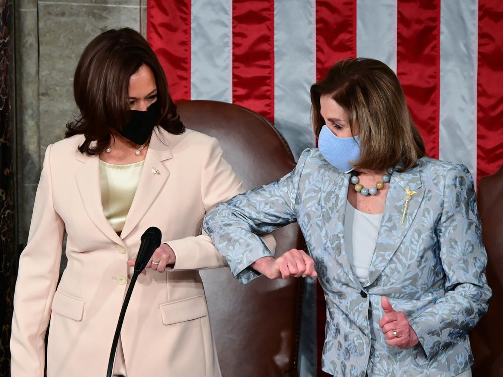 Vice President Harris, left, greets House Speaker Nancy Pelosi. In a historic first, the two Democrats from California sat behind Biden as he delivered his address.