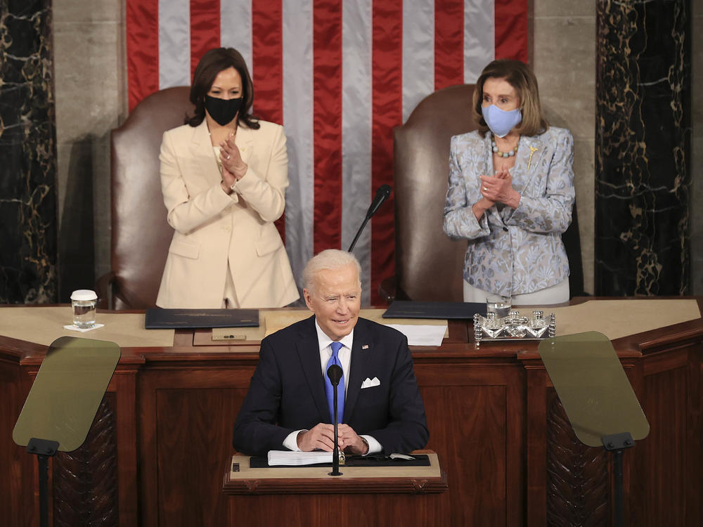 In a historic first, President Biden was flanked by two women — House Speaker Nancy Pelosi and Vice President Harris — as he addressed a joint session of Congress at the U.S. Capitol on Wednesday.