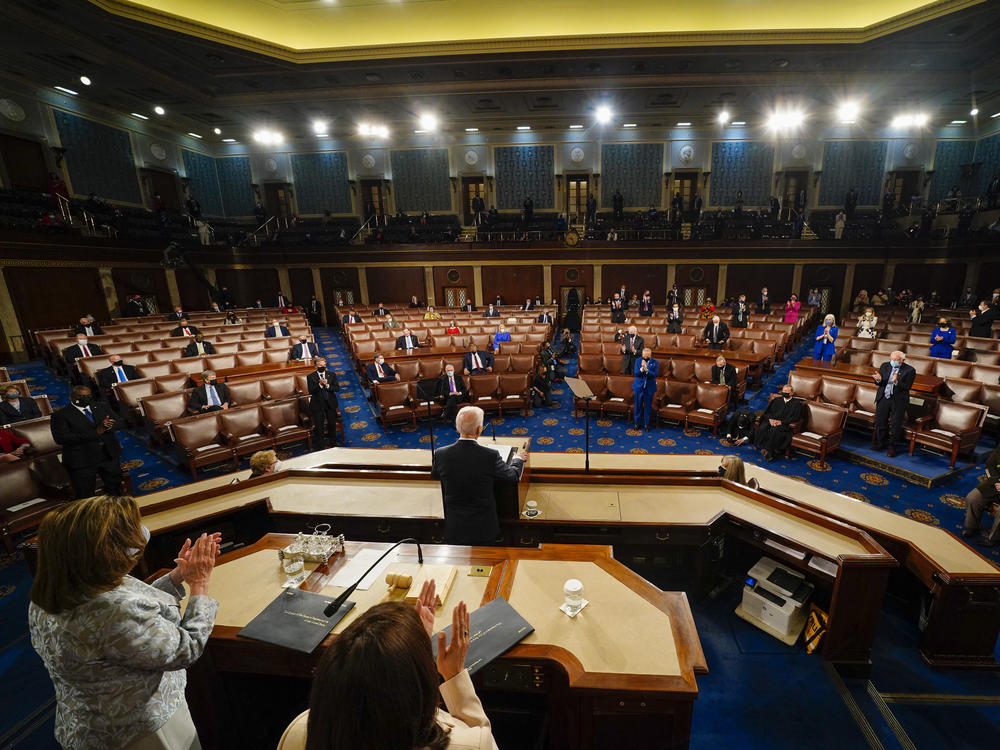 President Biden addresses a joint session of Congress on the eve of his 100th day in office, as Vice President Harris and House Speaker Nancy Pelosi stand behind him on the dais.