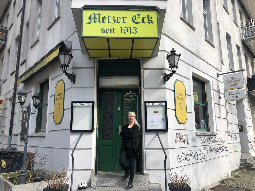 Sylvia Falkner stands in front of her Berlin pub, Metzer Eck, which has been owned by four generations of the same family since 1913. She is one of thousands of small German business owners struggling to keep their businesses open in an extended pandemic lockdown.
