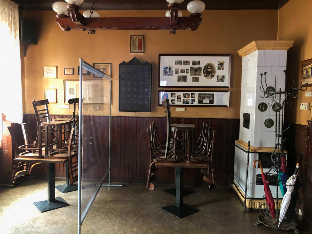 Empty tables at Metzer Eck, which was forced to close due to lockdown guidelines. The walls are filled with grainy black-and-white photos of generations of regulars. The pub started a food delivery service, but 