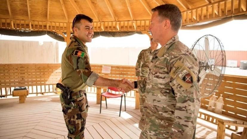 Afghan Gen. Sami Sadat (left) greets U.S. Gen. Scott Miller, the head of the U.S.-led coalition in Afghanistan, in the southern province of Helmand earlier this month. U.S. and NATO forces are withdrawing within months, raising questions about how the Afghan military will fare on its own against the Taliban. 