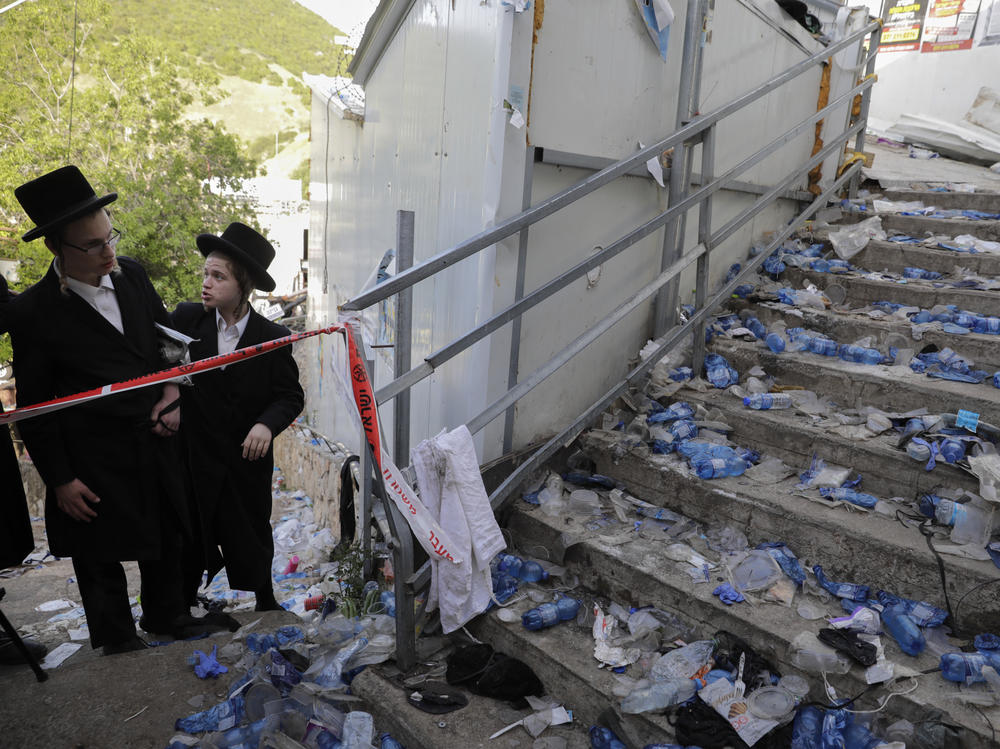 Ultra-Orthodox Jews look at the scene where dozens of people were killed and some 150 injured in a stampede during the Lag BaOmer festival at Mount Meron in northern Israel on Friday.