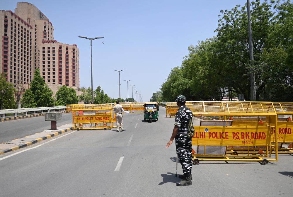 Police stop vehicles April 18 at a New Delhi checkpoint aimed at enforcing a weekend lockdown the government imposed in the wake of rising COVID-19 cases.