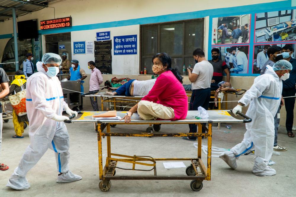Health workers transport a COVID-19 patient in a hospital complex last week in New Delhi.