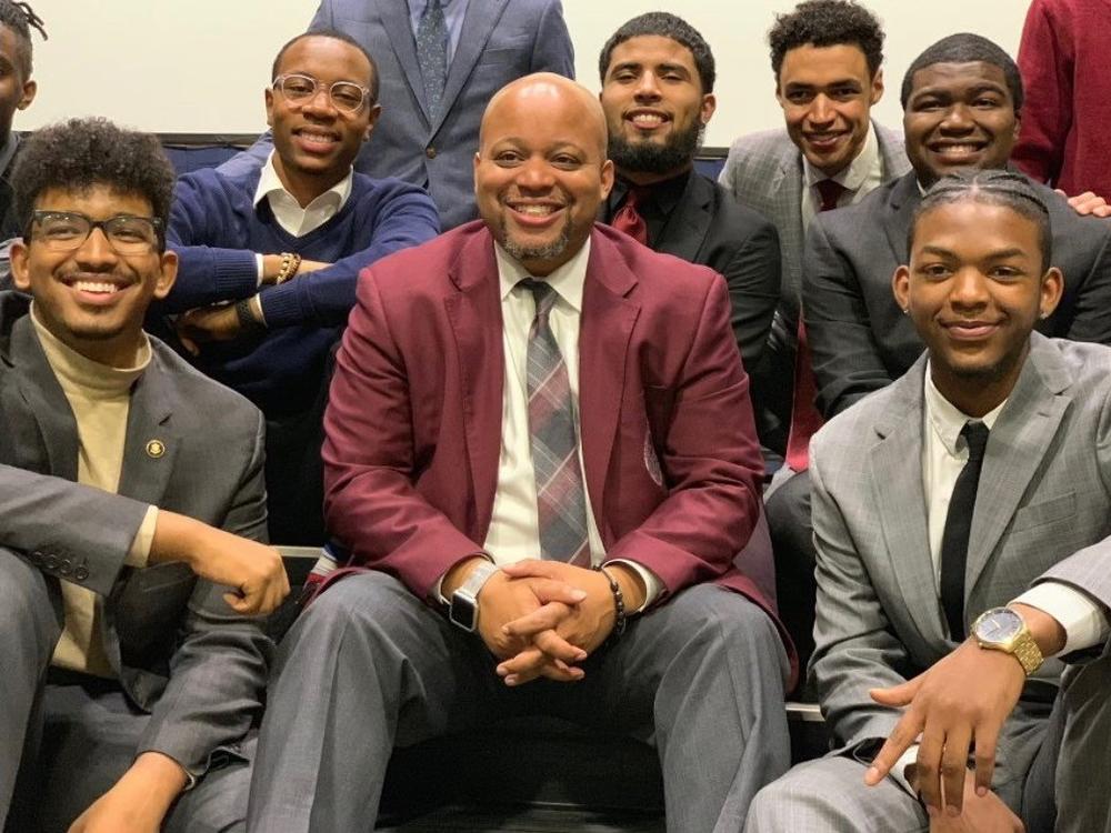 Members of the Morehouse College speech and debate team at the 2019 Pi Kappa Delta National Championship at Hofstra University. Coach Kenneth Newby is seen at the center, and student debater Daniel Edwards is at front left.