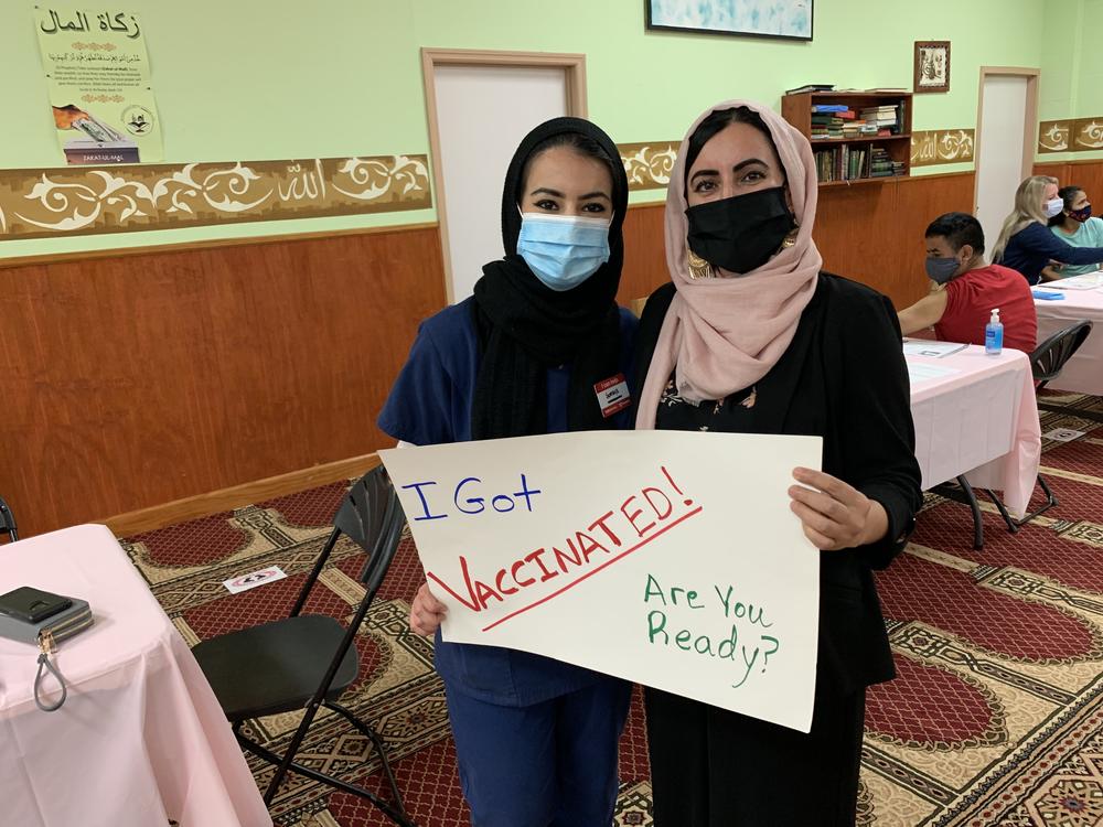 Sumaya Muhamed and her mother, Suad Abdulla, tout the latter's second vaccine dose at the Salahadeen Center in Nashville, Tenn. After weeks of affectionate cajoling and patient explanation, Muhamed convinced her mother to get the shot.