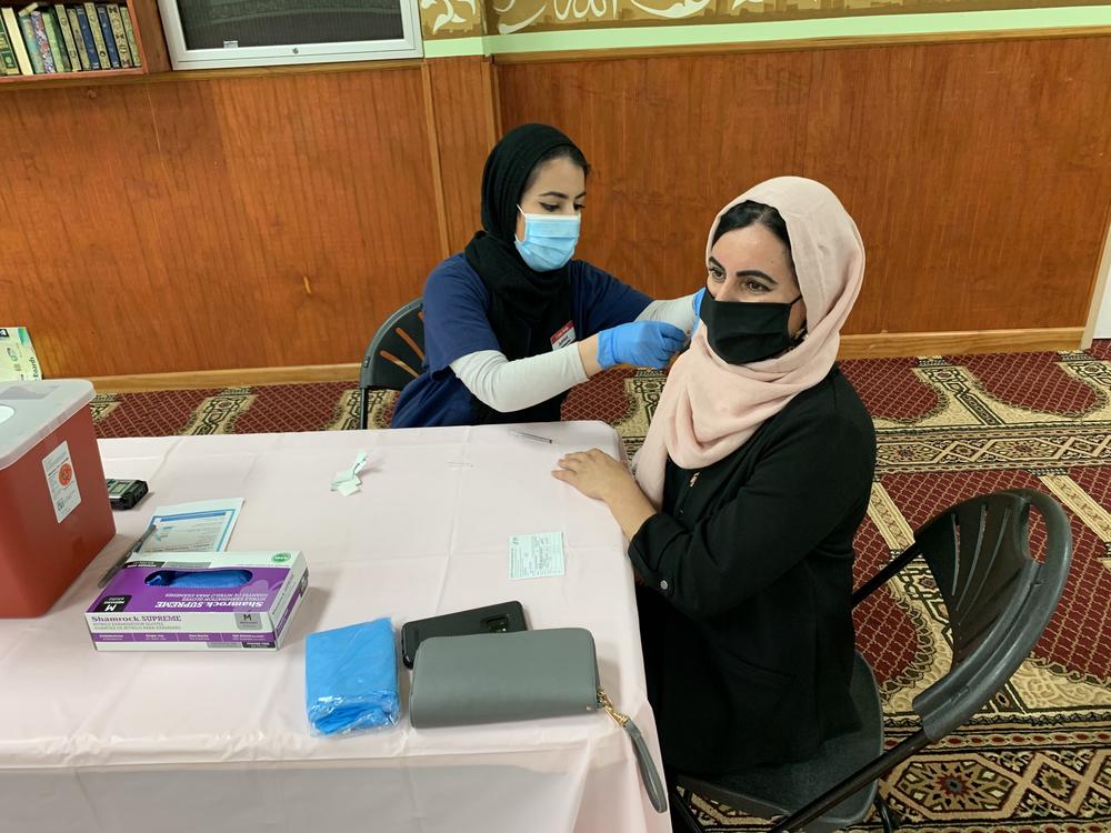 At the community center for Kurdish Americans in Nashville, Muhamed vaccinates her mother. The pre-med major, a trained pharmacy technician, spent weeks convincing her mother, who was in refugee camps as a child, that the vaccine is safe and effective.