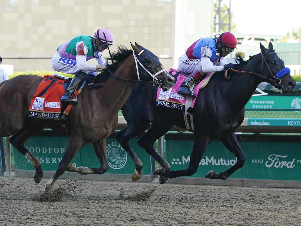 John Velazquez, right, rides Medina Spirit ahead of Florent Geroux aboard Mandaloun to win the 147th running of the Kentucky Derby at Churchill Downs on Saturday in Louisville, Ky.