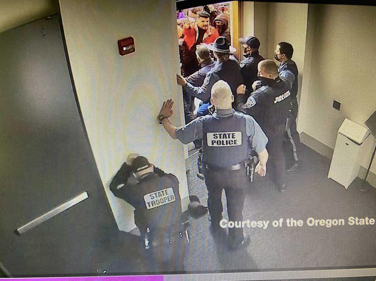 Surveillance video captured Dec. 21 at the Oregon State Capitol shows a crowd of protesters trying to fight their way past Oregon State Police troopers.