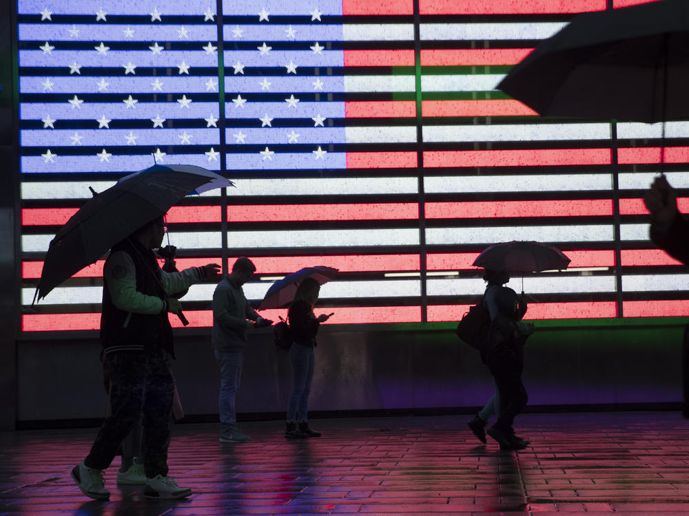 People holding umbrellas walk through New York City's Times Square in 2019. The U.S. Census Bureau plans to change how it protects the confidentiality of people's information in the detailed demographic data it produces through the 2020 count.