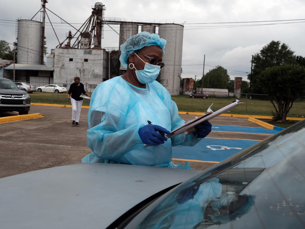 Medical workers with Delta Health Center prepare to vaccinate people in Leland, Miss., last week. In some places, rural hospital workers have been slow to get the vaccine themselves.