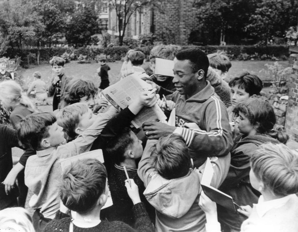 From a young age, Pelé's greatness was clear. Kids surrounded the Brazilian superstar to get an autograph.