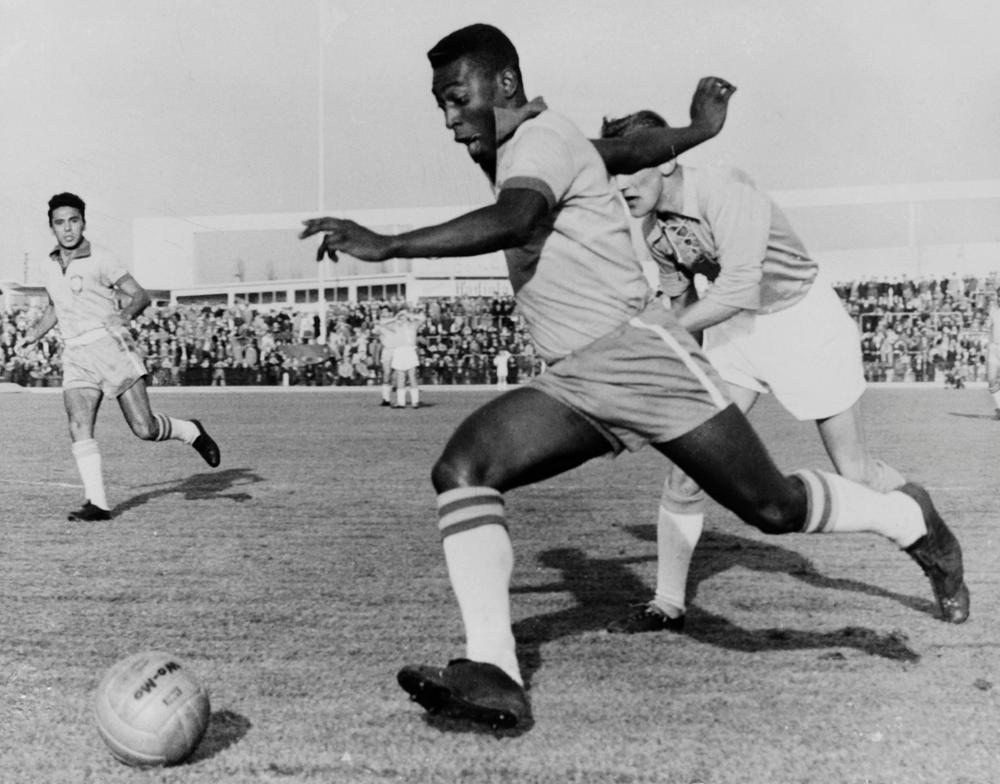 Brazilian forward Pelé dribbles past a defender during a friendly match in 1960.