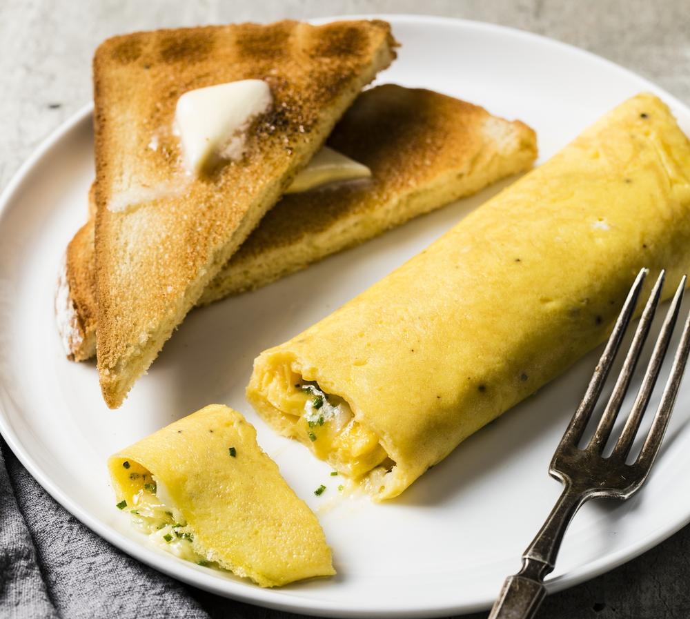 A French omelet, unlike its diner-style counterpart, is rolled, not folded, and include very little filling like vegetables and meats.