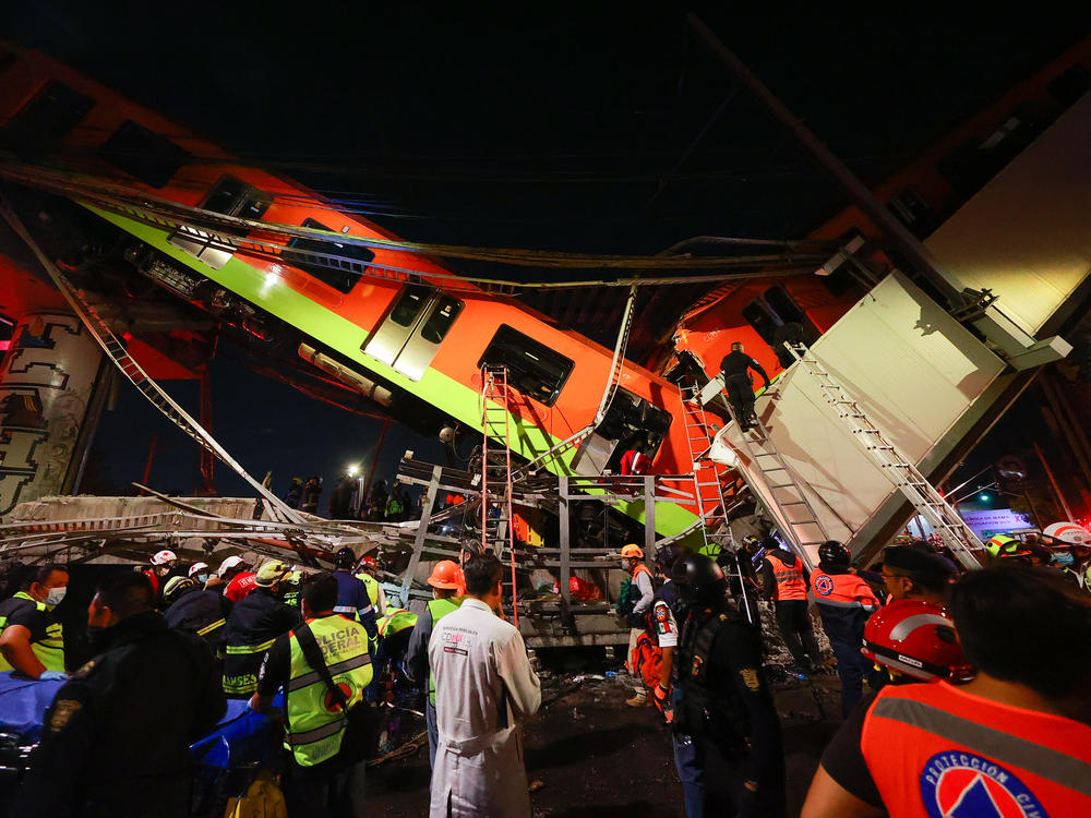 Emergency personnel search for survivors after a raised subway track collapsed Monday night in Mexico City.