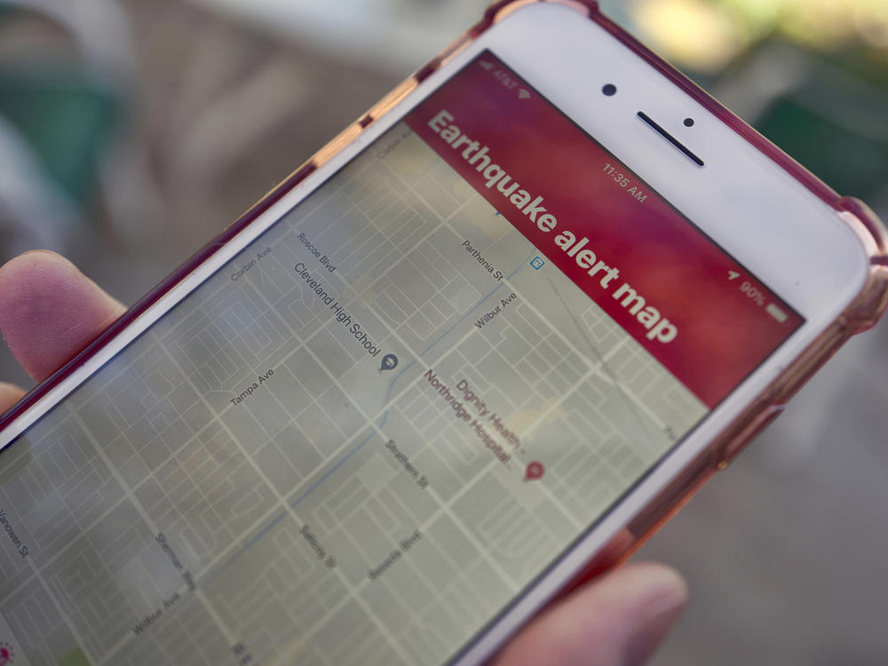 A mobile phone customer in Los Angeles looks at an earthquake warning application on an iPhone. An earthquake early warning system operated by the U.S. Geological Survey has been activated in Oregon, California and now Washington.