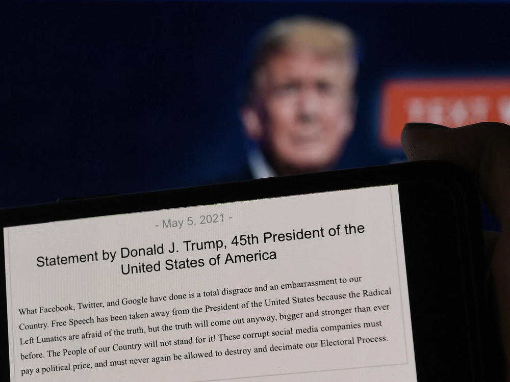 A statement from former President Donald Trump is seen in front of his Facebook page background. Facebook was justified in its decision to suspend Trump after the Jan. 6 insurrection, the company's Oversight Board said Wednesday.