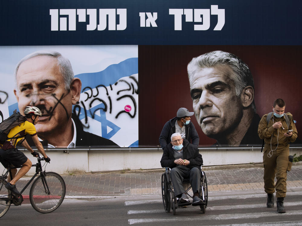 An election campaign billboard for the Likud party shows its leader, Prime Minister Benjamin Netanyahu (left), and opposition party leader Yair Lapid, in Ramat Gan, Israel, days before that country's election in March. The banner reads 