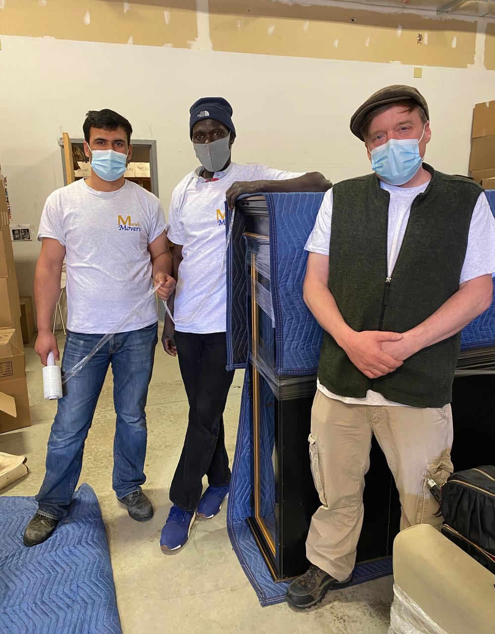 Anur Abdella (center), a refugee from Sudan, with colleagues at the moving company where he works in Connecticut. A multifaith team of local volunteers has helped Abdella, his wife and children get settled into their new life in the U.S.