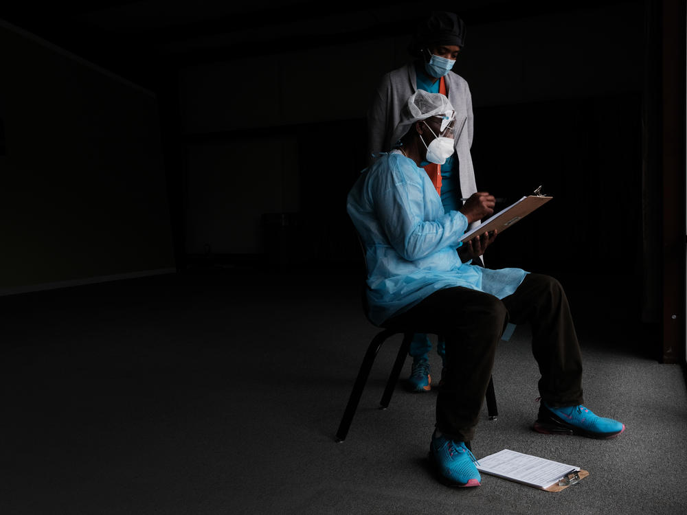 Medical workers wait to vaccinate people at a pop-up COVID-19 vaccination clinic last month in Hollandale, Miss.