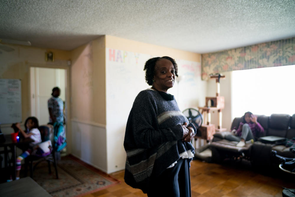 DonnaLee Norrington in her living room with grandchildren. Norrington and her younger sister MaryJosephine Norrington own a three-bedroom house in Compton, where three generations of her family currently live.