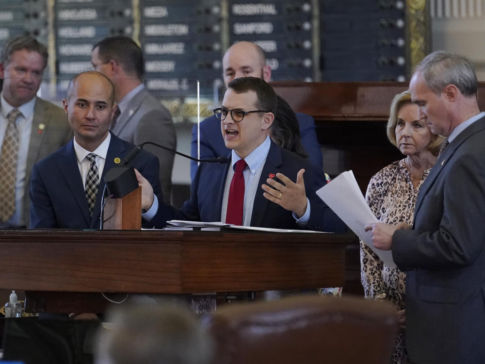 Republican state Rep. Briscoe Cain (center) stands with co-sponsors as he speaks in favor of the election bill Thursday in the House chamber at the Texas Capitol in Austin.