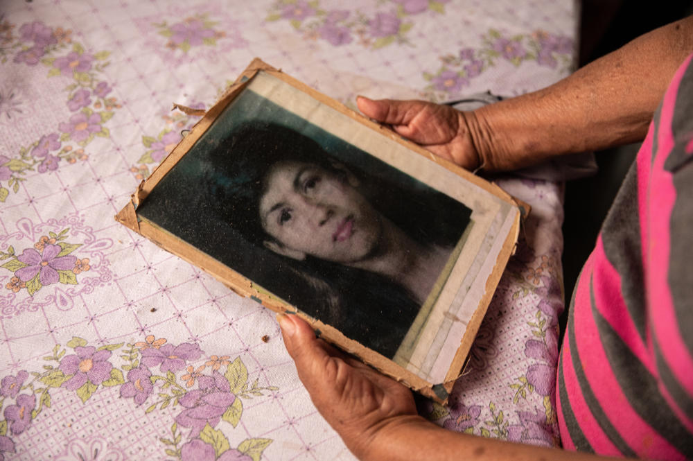 Edita Maldonado, mother of Rosa Lidia Perez, holds a photograph of her once-disappeared daughter, whom she found with support from COFAMIPRO. Maldonado found her daughter and brought her home before she passed away in 2004.