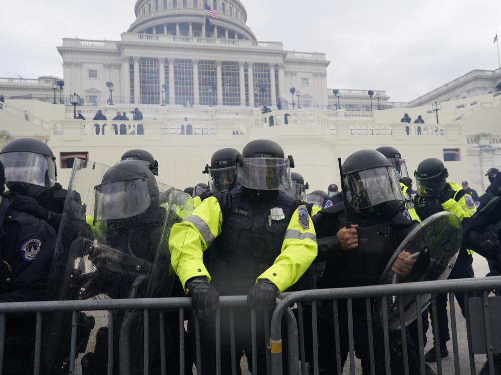 Law enforcement, including Capitol Police officers, try to hold back rioters at the Capitol on Jan. 6.
