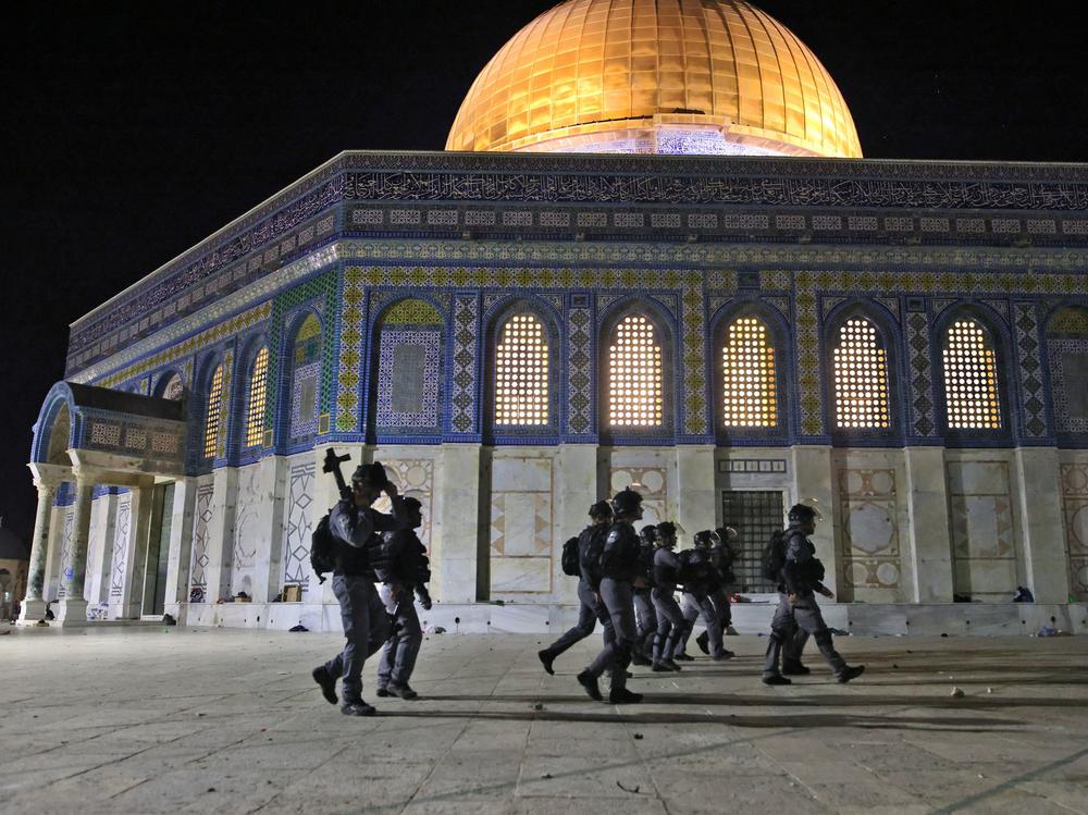 Israeli security forces deploy next to the Dome of the Rock mosque amid clashes with Palestinian protesters at the Al-Aqsa Mosque compound in Jerusalem on Friday.