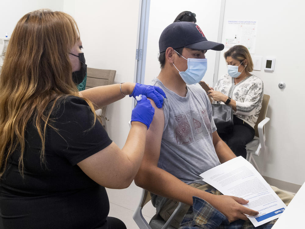 This 16-year-old got a Pfizer-BioNTech COVID-19 shot late last month at the UCI Health Family Health Center in Anaheim, Calif. Students as young as 12 are now eligible to get the vaccine, too, the FDA says.