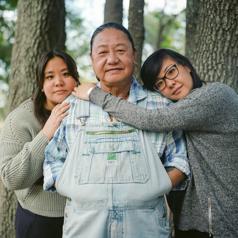 Marlon Chen, and his two daughters Victoria and Linda Chen, stand for a portrait. Marlon Chen immigrated to the United States in the 1980s from Taiwan and now runs a bonsai and rock shop off a state highway outside of Austin.