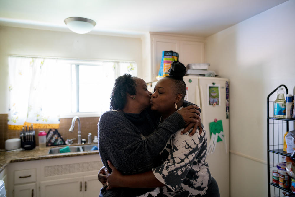 DonnaLee Norrington embraces her daughter Summer at her home.