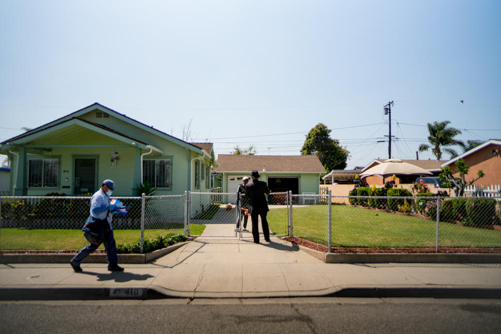 Robert Lee Johnson speaks with a resident in his childhood neighborhood. He says Compton felt like a 