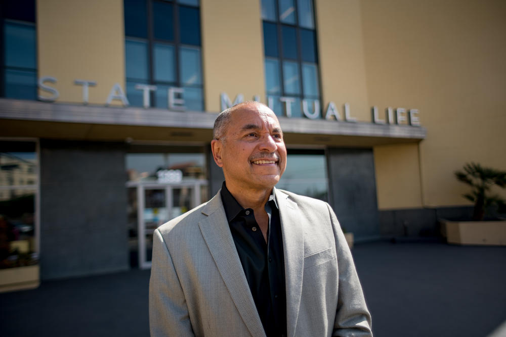 Ivan Houston stands outside the historic Golden State Mutual Life Insurance Company while sharing the history of his grandfather's company.