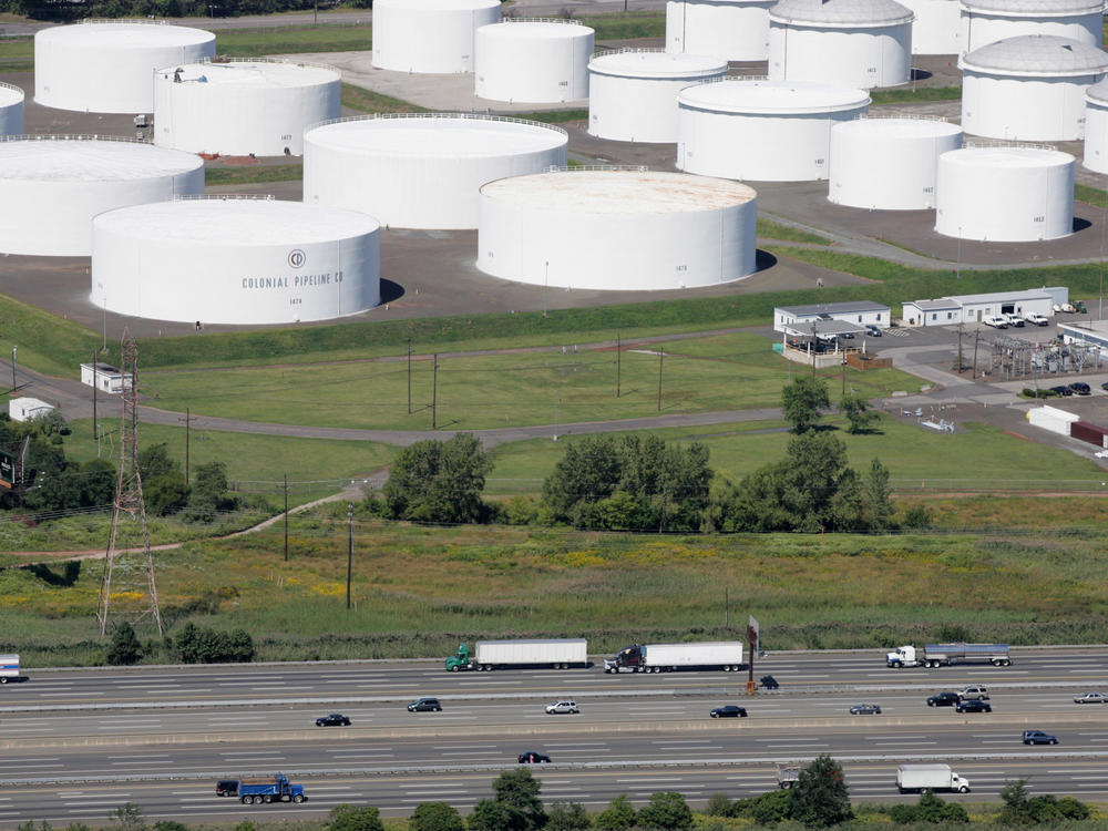 Traffic on I-95 passes oil storage tanks owned by the Colonial Pipeline Co. in Linden, N.J. An cybersecurity attack has shut down Colonial Pipeline, a major transporter of gasoline along the East Coast.