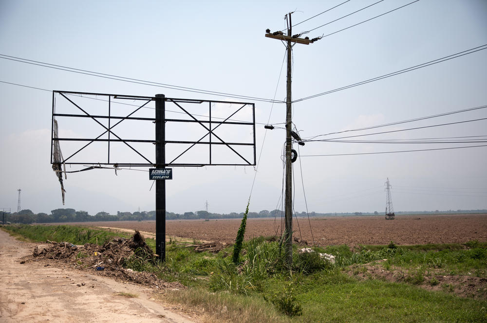 Entire crops in the Sula Valley, on Honduras' Atlantic lowlands, were wiped out in the flooding. Along the roadways that encircle San Pedro Sula, utility poles and billboards remain partially or totally destroyed by the hurricanes' high winds.