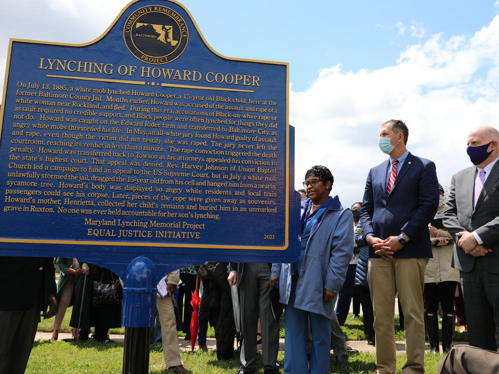 Maryland Gov. Larry Hogan, far right, Baltimore County Executive John Olszewski and Maryland House Speaker Adrienne Jones stand next to a new historic marker on Saturday in Towson, Md., that memorializes Howard Cooper, a 15-year-old who was dragged from a jailhouse and hanged by a mob in 1885.