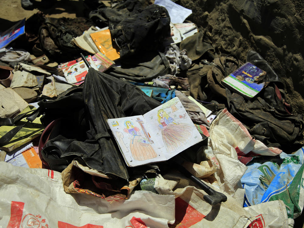 Books, notebooks and other school supplies are scattered after deadly bombings on Saturday near a school in Kabul.