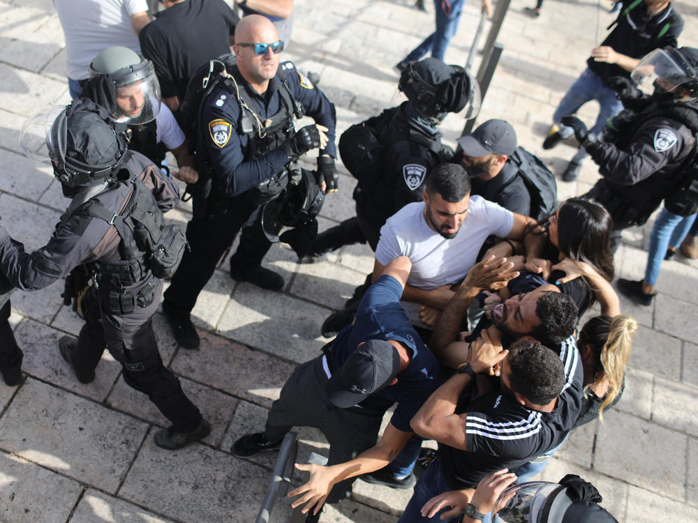 Undercover Israeli security force members arrest a Palestinian protester at Damascus Gate in Jerusalem on Monday.