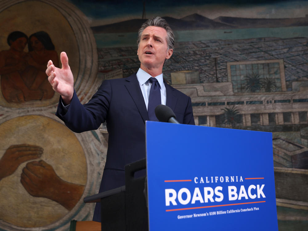 California Gov. Gavin Newsom speaks during a press conference in Oakland, Calif., on Monday where he announced a new round of $600 stimulus checks residents making up to $75,000 a year. Newsom also announced a projected $75.7 billion budget surplus compared to last year's projected $54.3 billion shortfall.